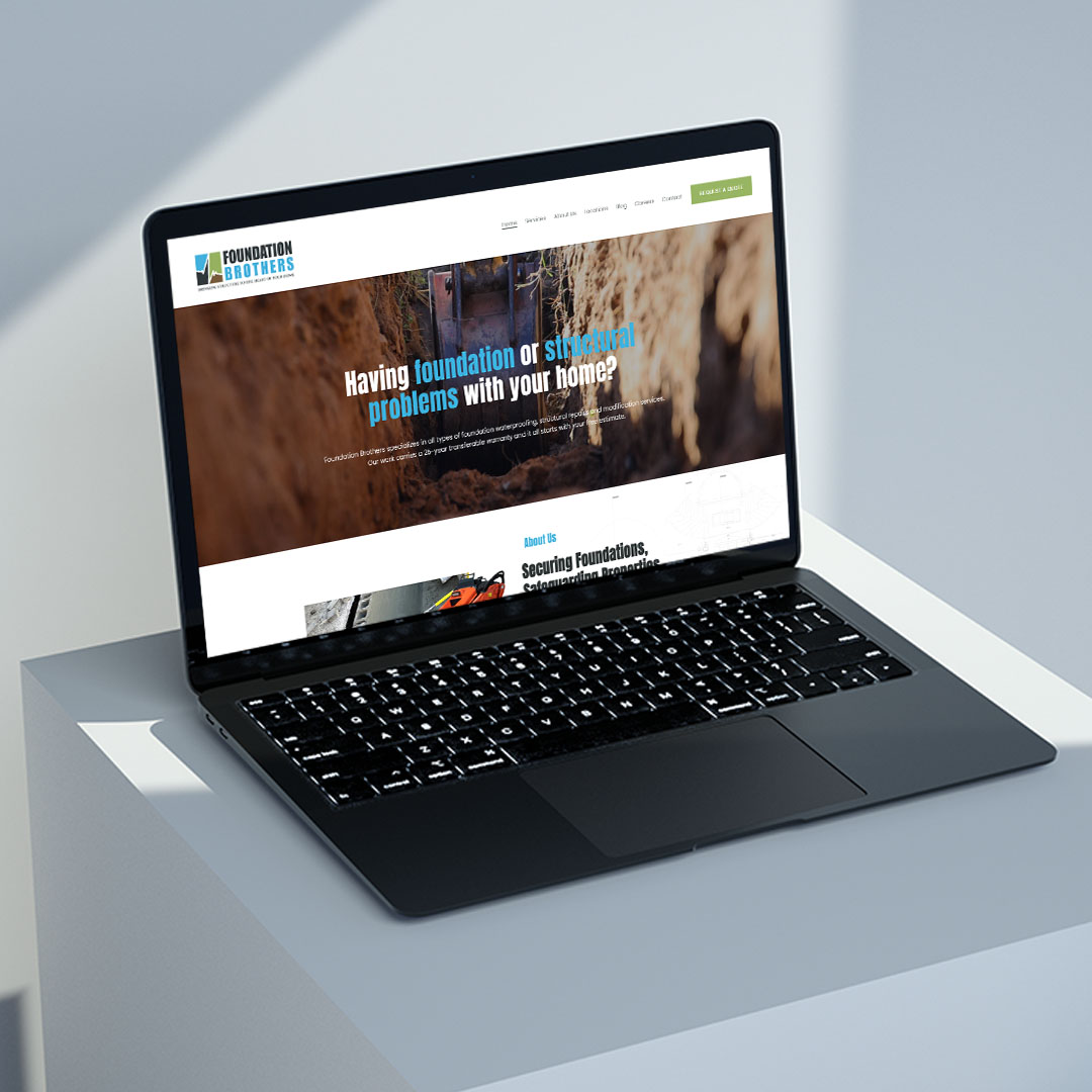 Angled view of the Foundation Brothers website on a laptop
