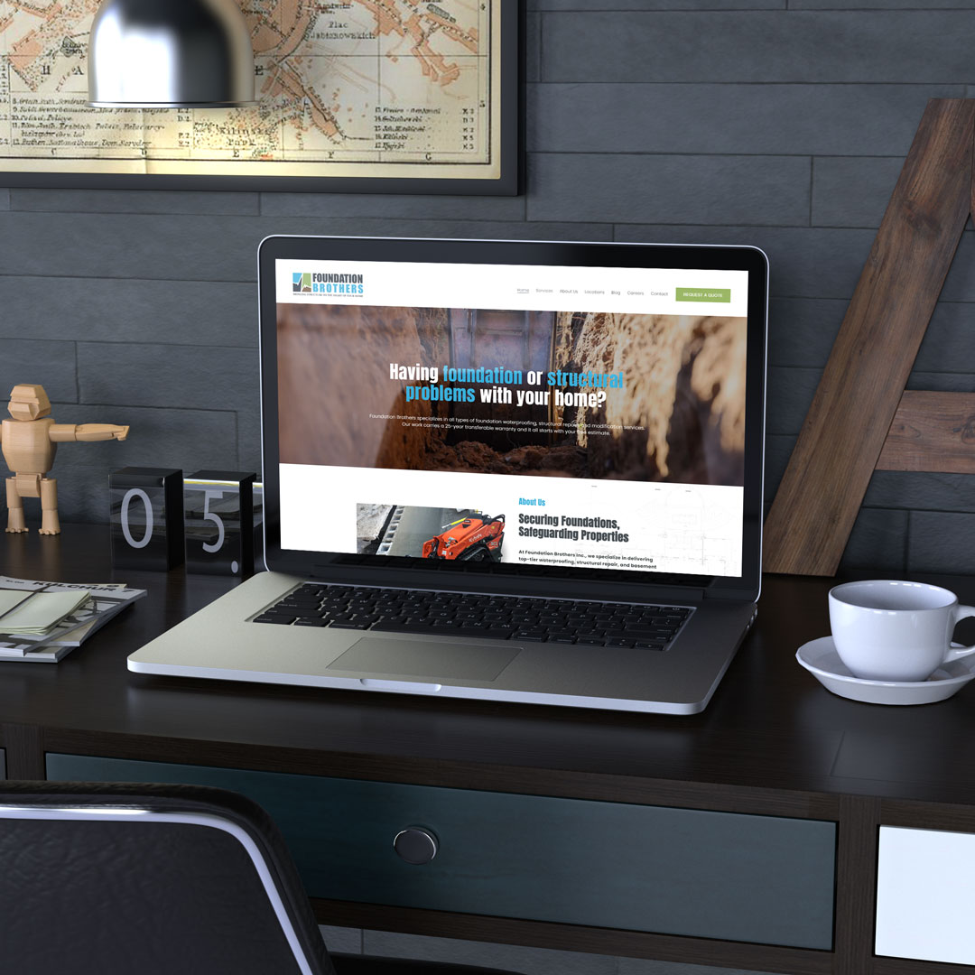 Foundation Brothers website shown on a laptop in an office setting